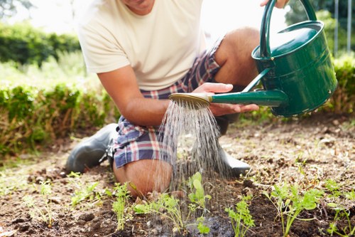Gardener pruning a hedge in Abbey Wood