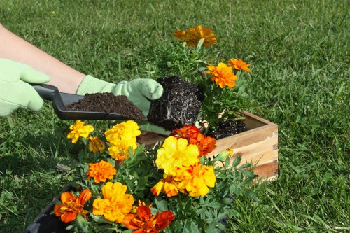 Gardener preparing soil in Abbey Wood garden